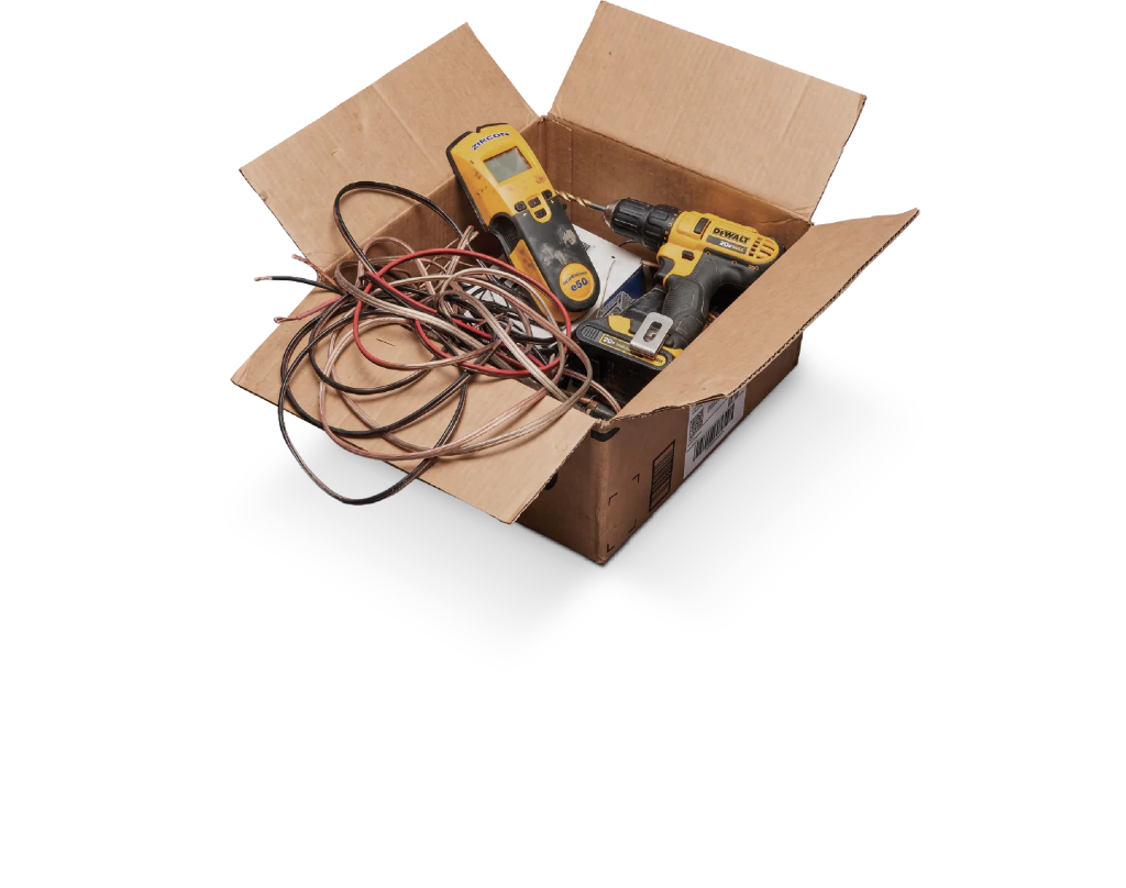 Open cardboard box of tangled speaker wire, a cordless drill, and other install tools